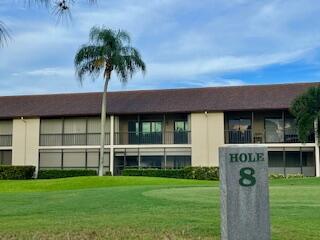 102 Pinecrest Circle, Unit C Jupiter, FL 33458 - Photo 33 of 38 a front view of a house with a garden