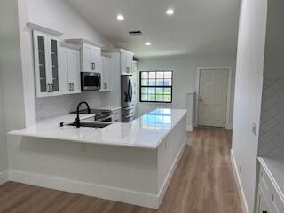 102 Pinecrest Circle, Unit C Jupiter, FL 33458 - Photo 6 of 38 a view of a kitchen with a sink and a window