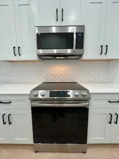 a stove top oven sitting inside of a kitchen