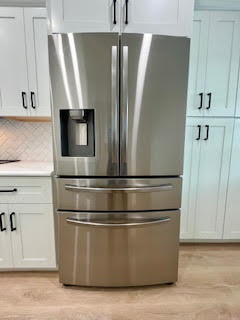 102 Pinecrest Circle, Unit C Jupiter, FL 33458 - Photo 9 of 38 a view of kitchen with stainless steel appliances wooden floor and window