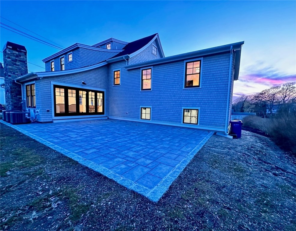 166 Ruggles Avenue Newport, RI 02840 - Photo 45 of 50 Dusk shot of behind house with large patio for indoor/outdoor entertaining.