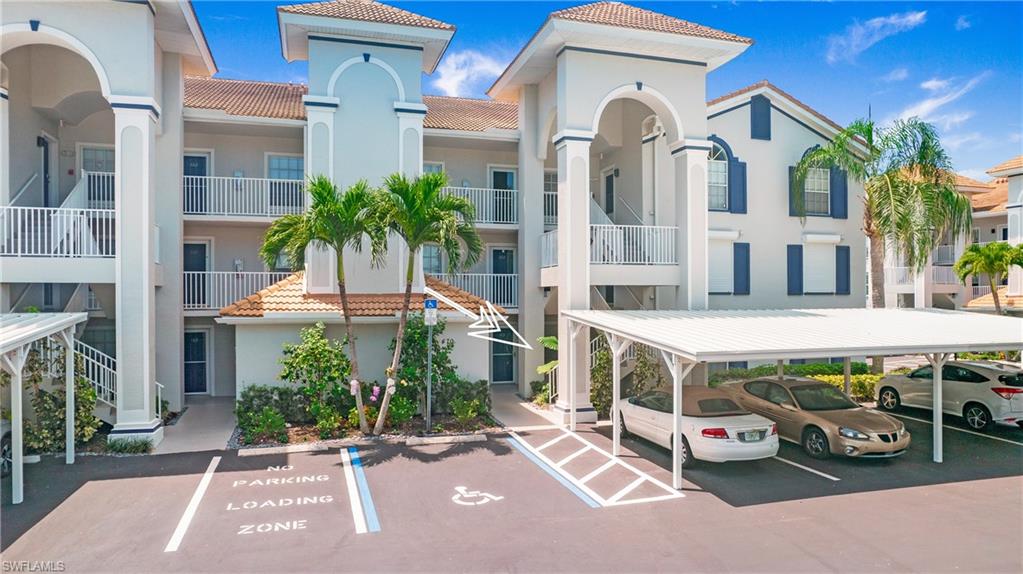 470 Bermuda Cove Way, Unit 2104 Naples, FL 34110 - Photo 28 of 35 View of building exterior featuring covered and uncovered parking