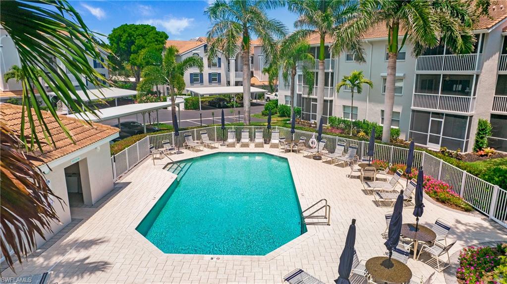 470 Bermuda Cove Way, Unit 2104 Naples, FL 34110 - Photo 6 of 35 Community pool with fence and a patio area