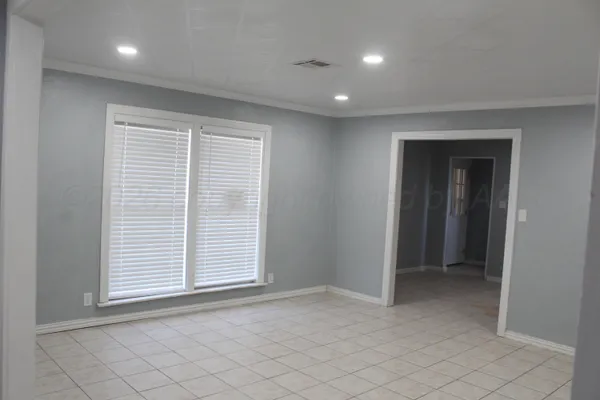 a view of an empty room with a window