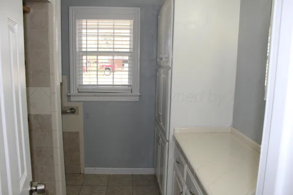 a bathroom with a tub and shower