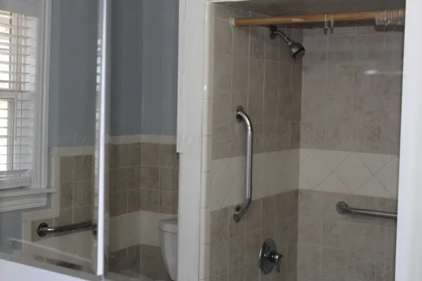 a bathroom with a glass shower door