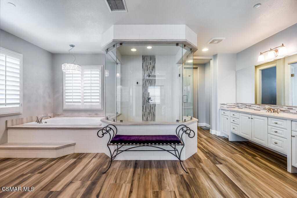 7377 Woods Court Moorpark, CA 93021 - Photo 11 of 29 a spacious bathroom with a double vanity sink a mirror and a bathtub