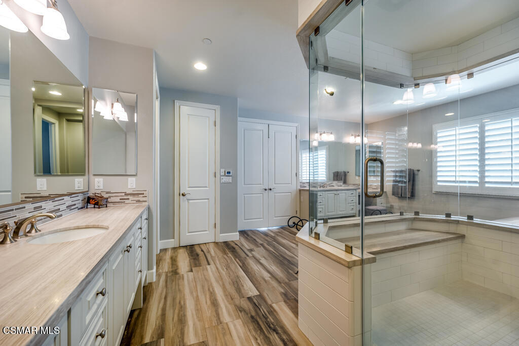 7377 Woods Court Moorpark, CA 93021 - Photo 12 of 29 a bathroom with a sink double vanity granite tub shower and a mirror