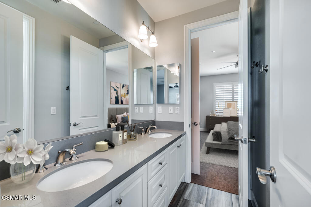 7377 Woods Court Moorpark, CA 93021 - Photo 15 of 29 a en suite bathroom with a double vanity sink and a mirror