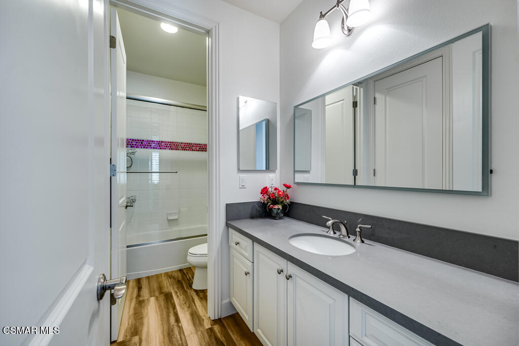 7377 Woods Court Moorpark, CA 93021 - Photo 17 of 29 a bathroom with a sink vanity granite and a mirror