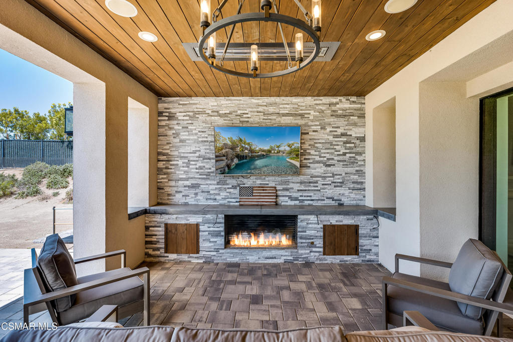 7377 Woods Court Moorpark, CA 93021 - Photo 20 of 29 a living room with furniture a fireplace and a table