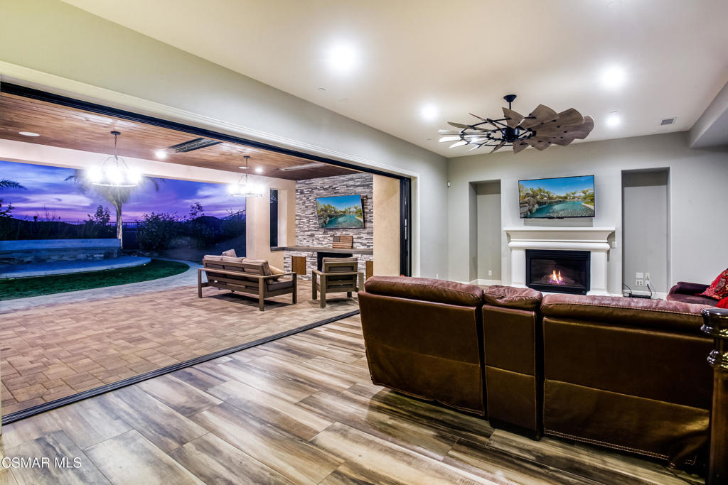 7377 Woods Court Moorpark, CA 93021 - Photo 2 of 29 a living room with furniture a fireplace and a flat screen tv
