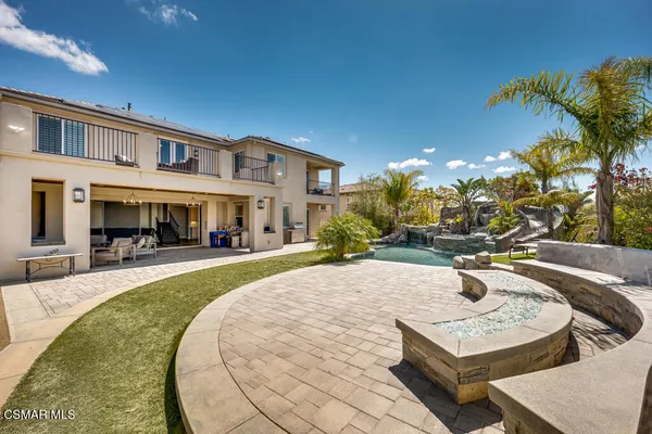 a view of a house with swimming pool and sitting area