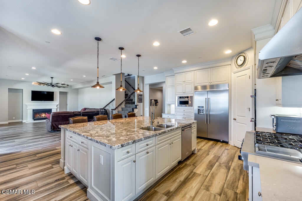 7377 Woods Court Moorpark, CA 93021 - Photo 6 of 29 a kitchen with stainless steel appliances granite countertop a sink stove and refrigerator