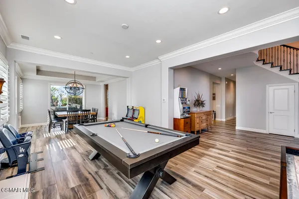 a living room with furniture a table and wooden floor