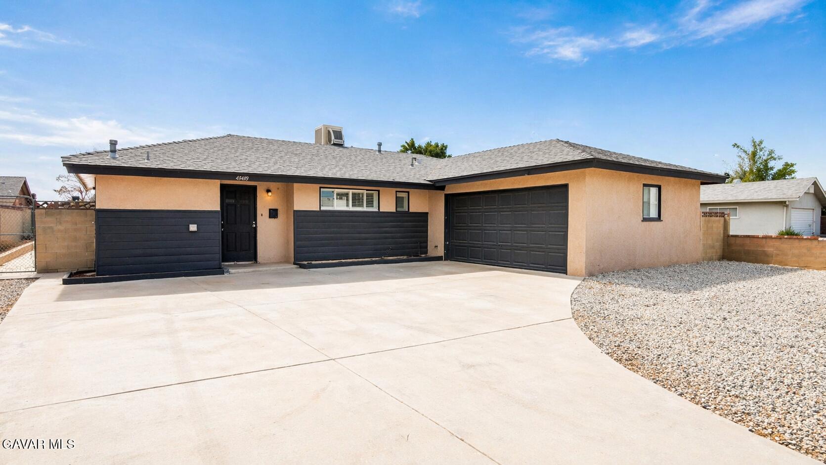 45409 Rodin Avenue Lancaster, CA 93535 - Photo 1 of 17 a front view of a house with a garage