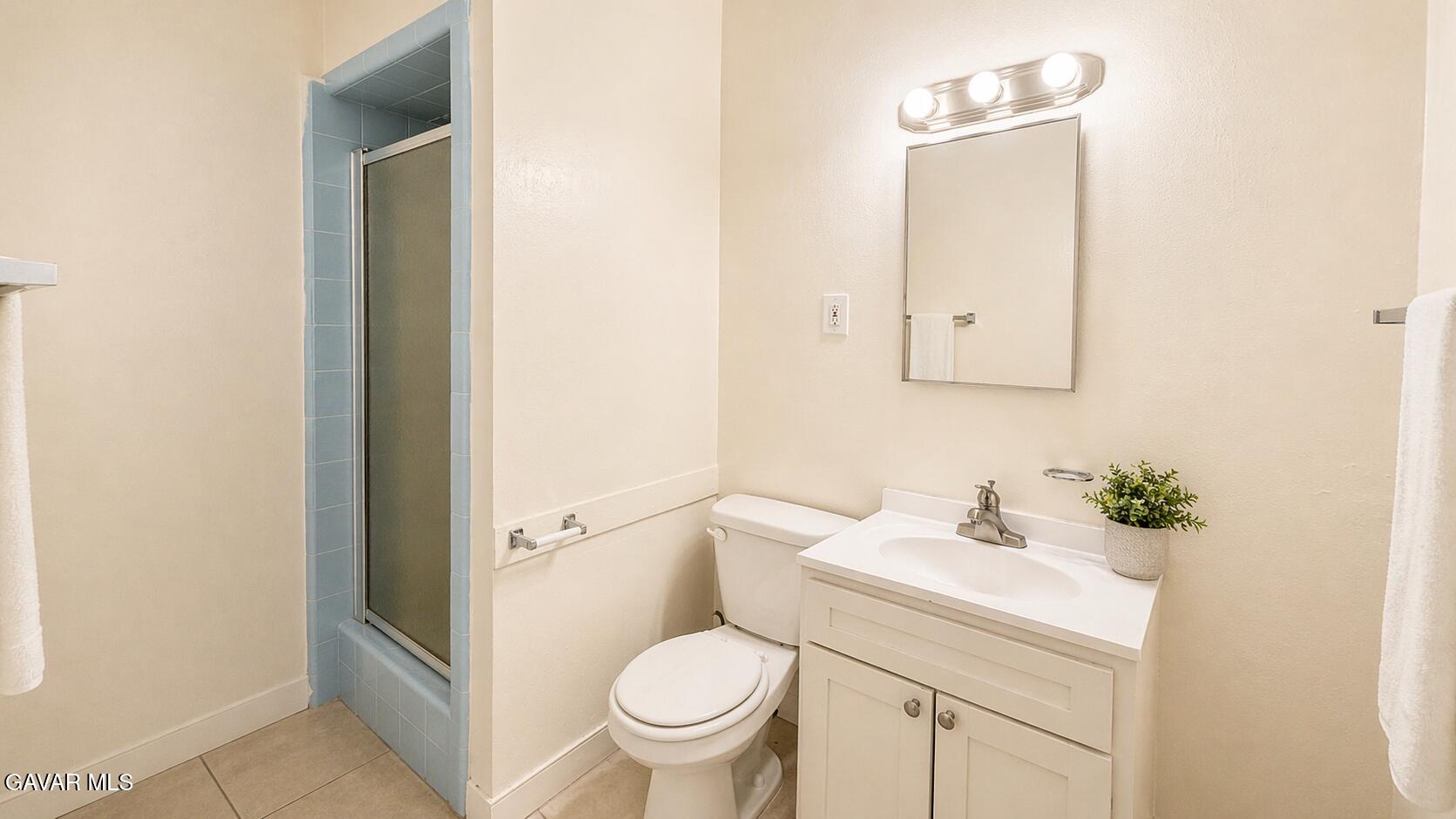 45409 Rodin Avenue Lancaster, CA 93535 - Photo 12 of 17 a bathroom with a sink toilet and a mirror
