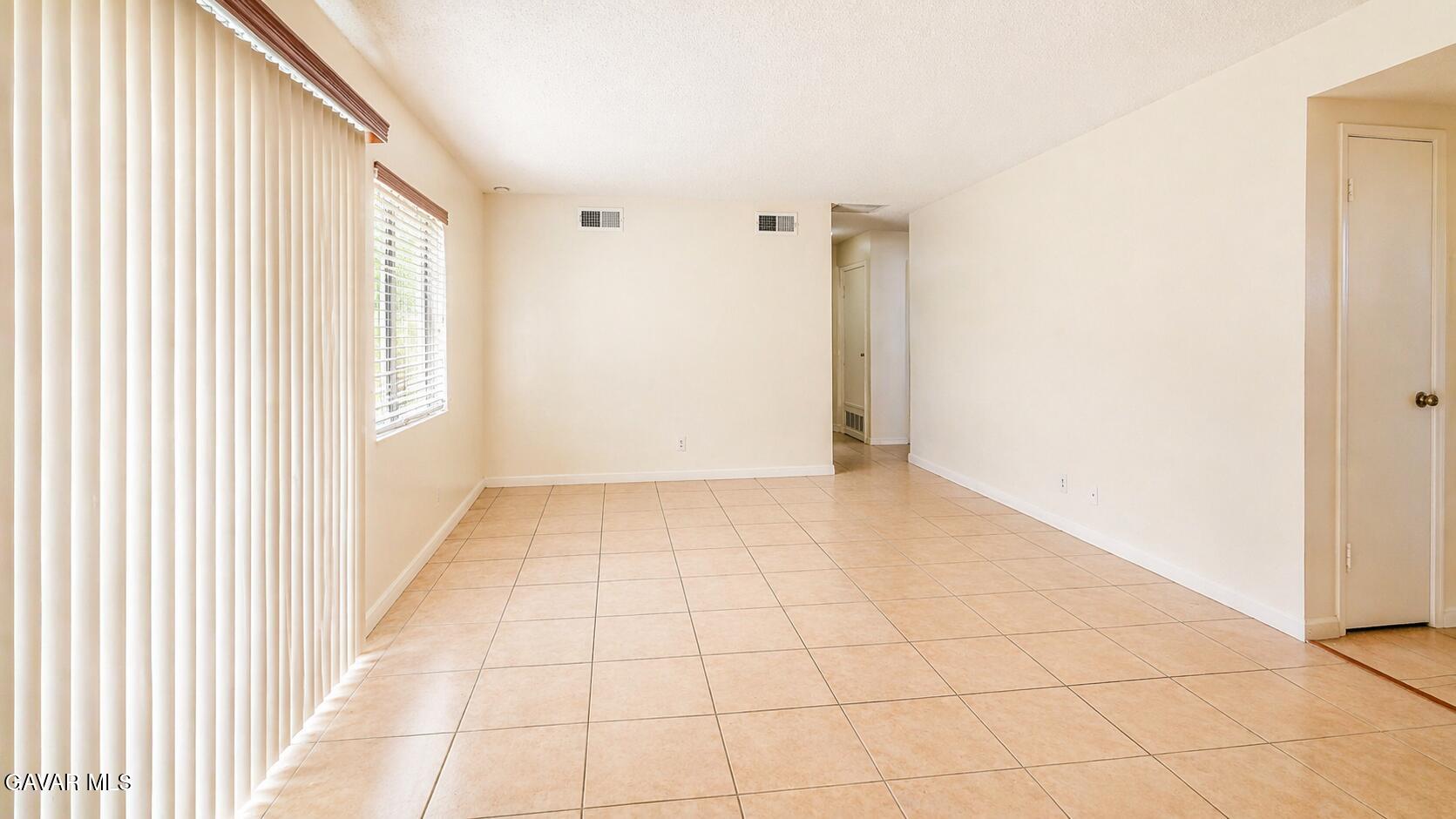 45409 Rodin Avenue Lancaster, CA 93535 - Photo 3 of 17 a view of an empty room and window