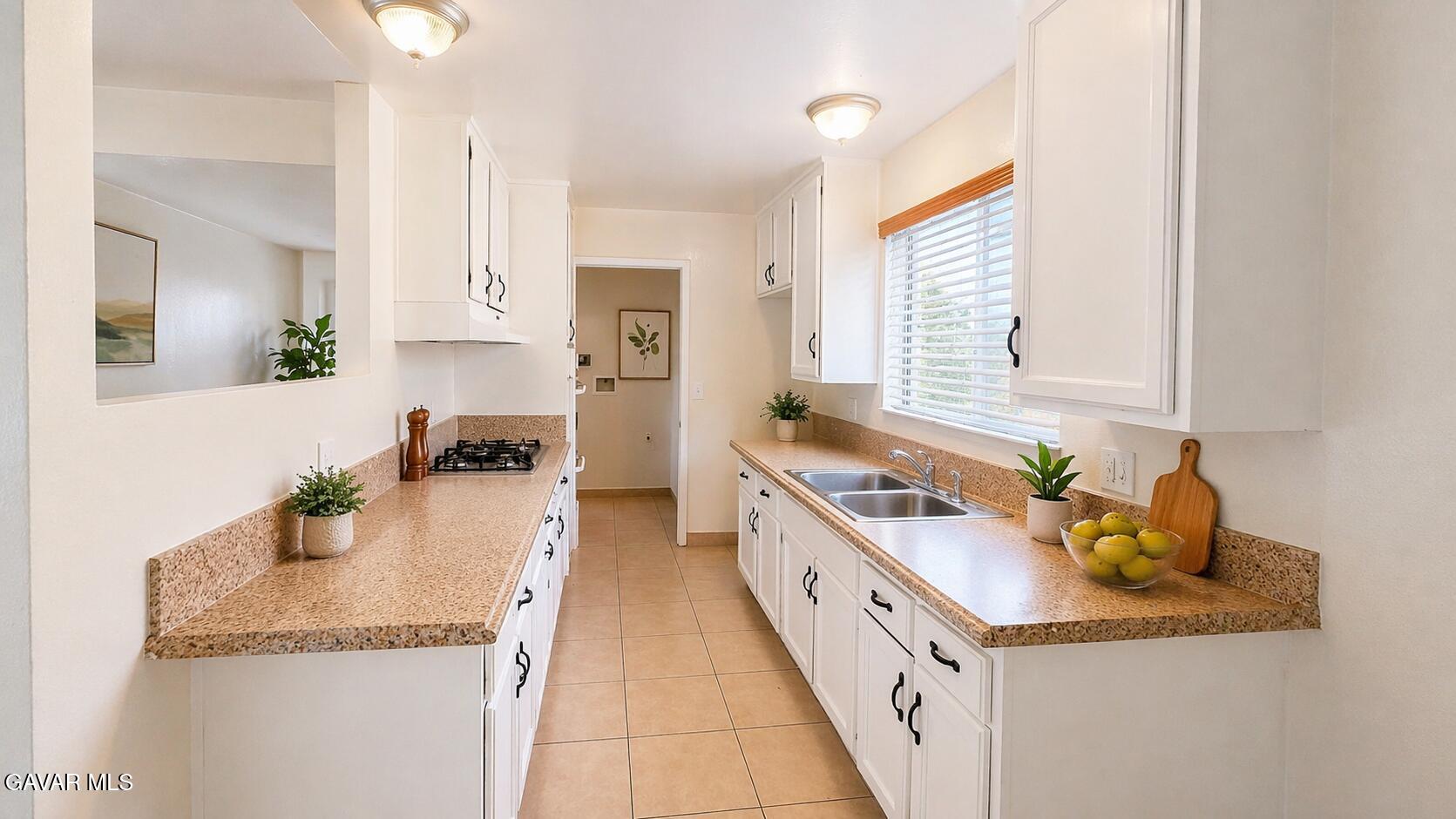 45409 Rodin Avenue Lancaster, CA 93535 - Photo 4 of 17 a kitchen with stainless steel appliances granite countertop a sink stove and cabinets