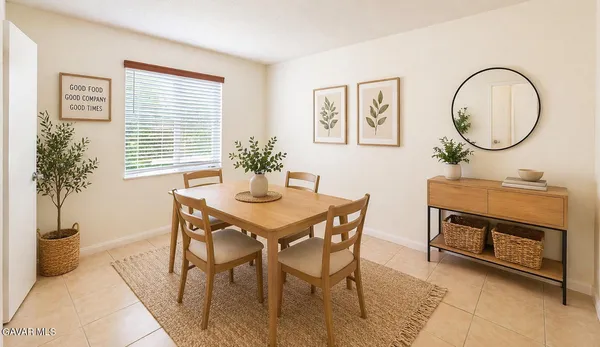 a view of a dining room with furniture and a potted plant