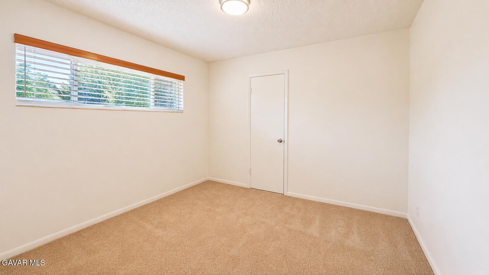 45409 Rodin Avenue Lancaster, CA 93535 - Photo 8 of 17 a view of an empty room with a window