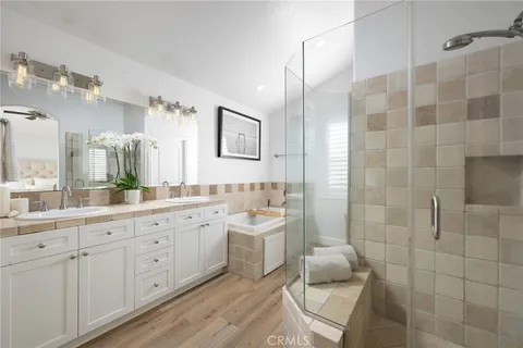 a bathroom with a double vanity sink mirror and shower