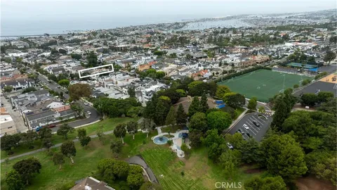 an aerial view of city lake and residential houses with outdoor space and trees