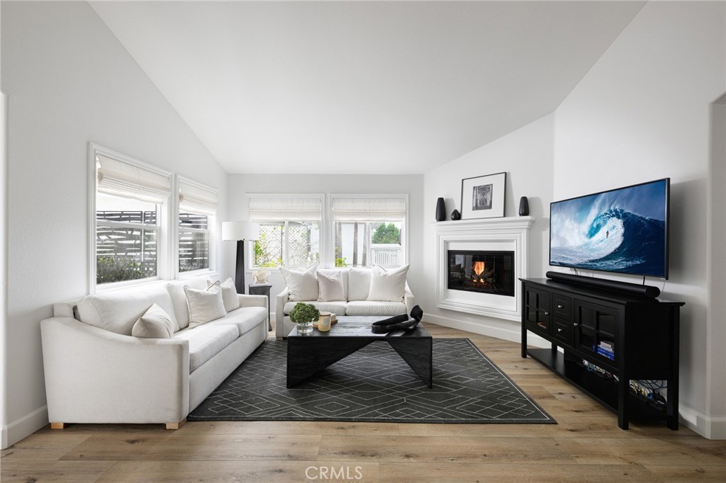 618 Iris Avenue, Unit B Corona del Mar, CA 92625 - Photo 2 of 20 a living room with furniture a rug and a fireplace