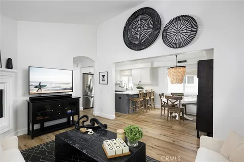 a view of dining room and livingroom with furniture wooden floor a rug and a chandelier