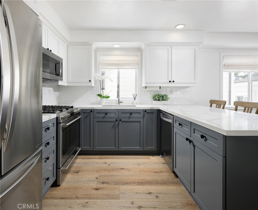 618 Iris Avenue, Unit B Corona del Mar, CA 92625 - Photo 6 of 20 a kitchen with stainless steel appliances granite countertop a sink stove and refrigerator