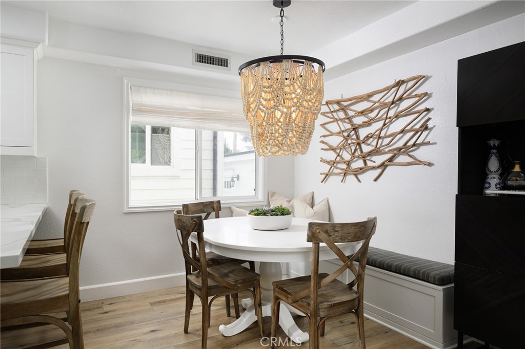 618 Iris Avenue, Unit B Corona del Mar, CA 92625 - Photo 7 of 20 a view of a dining room with furniture and wooden floor