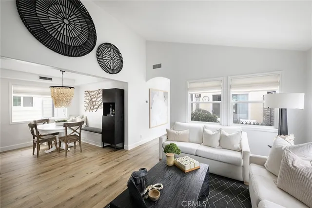 a living room with furniture wooden floor and a clock