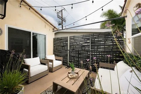 a balcony with table and chairs