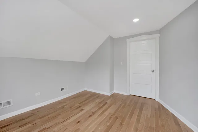 a view of a room with wooden floor