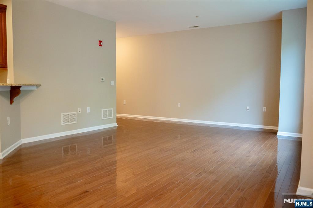 804 River Place Butler, NJ 07405 - Photo 13 of 32 a view of an empty room with wooden floor and a window