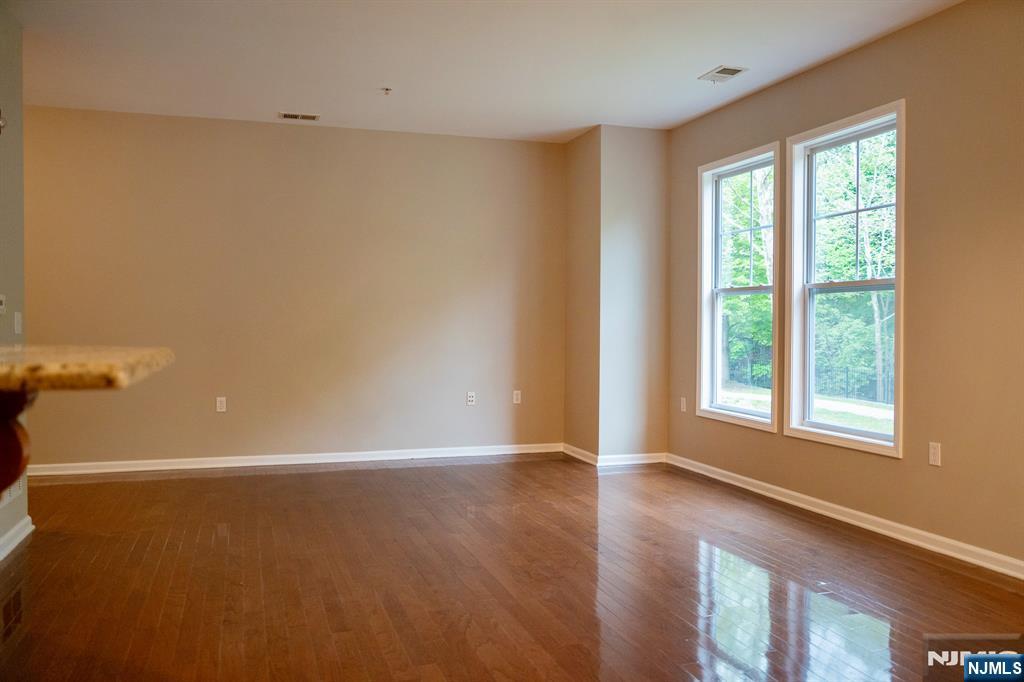 804 River Place Butler, NJ 07405 - Photo 14 of 32 wooden floor in an empty room with a window