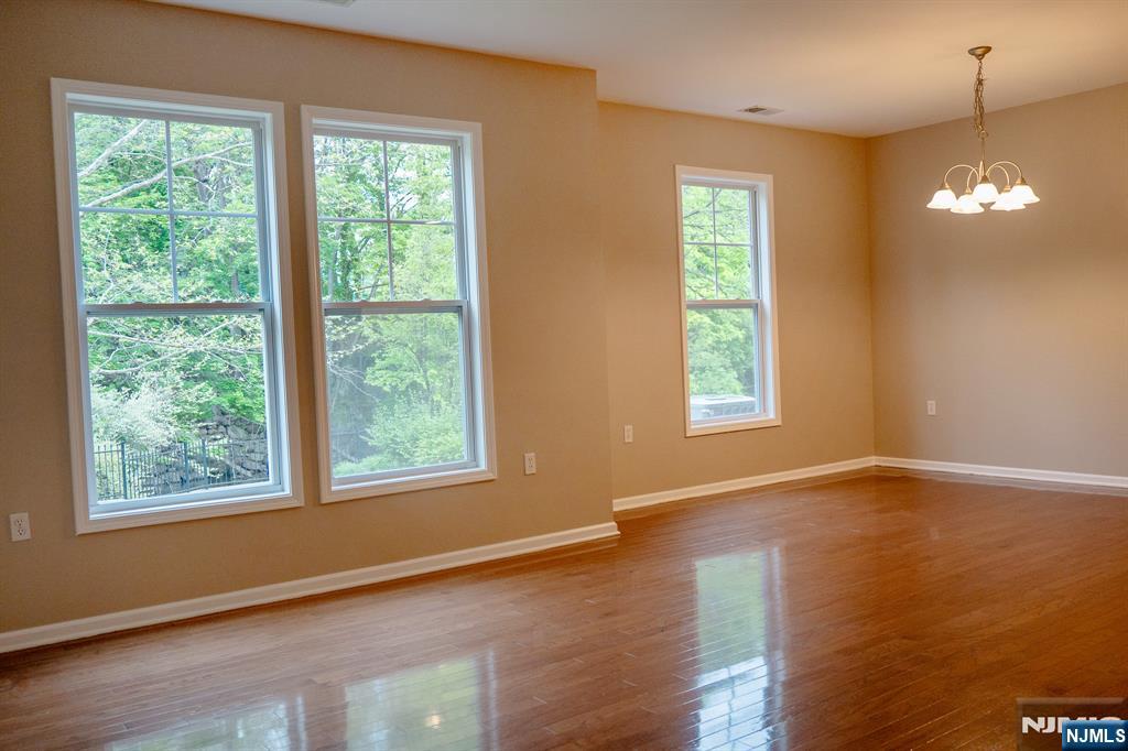 804 River Place Butler, NJ 07405 - Photo 15 of 32 a view of an empty room with wooden floor and windows