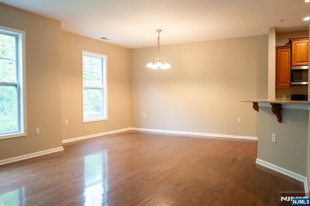 804 River Place Butler, NJ 07405 - Photo 16 of 32 wooden floor in an empty room with a window