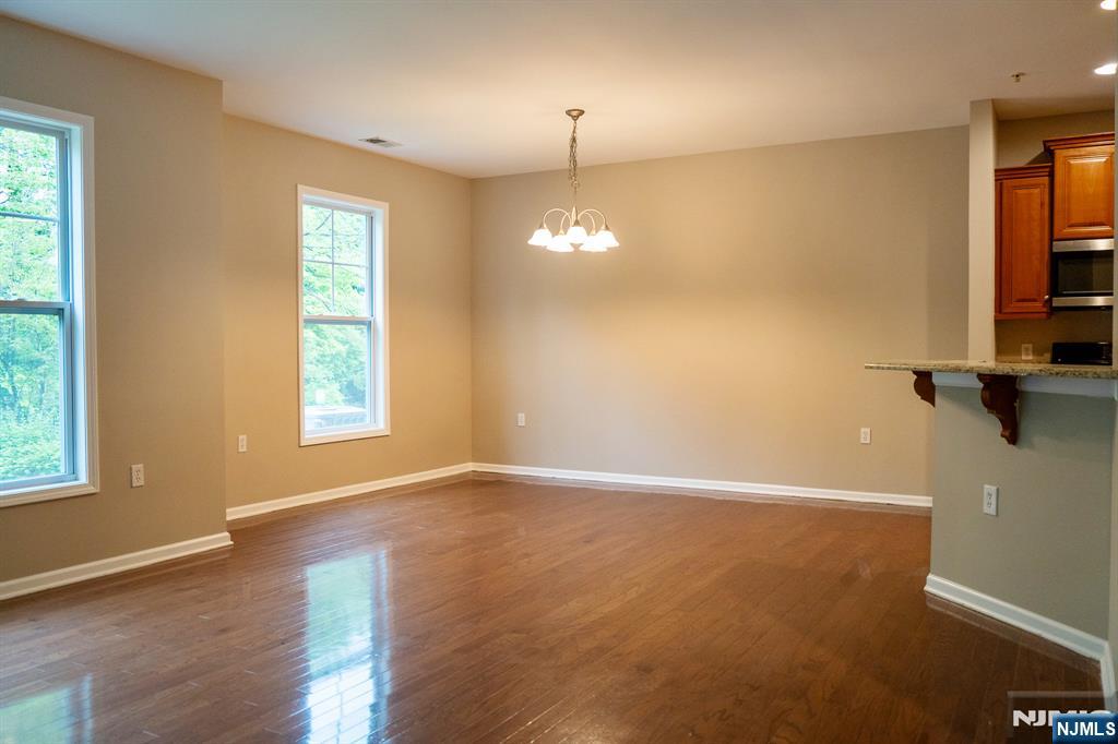 804 River Place Butler, NJ 07405 - Photo 17 of 32 wooden floor in an empty room with a window