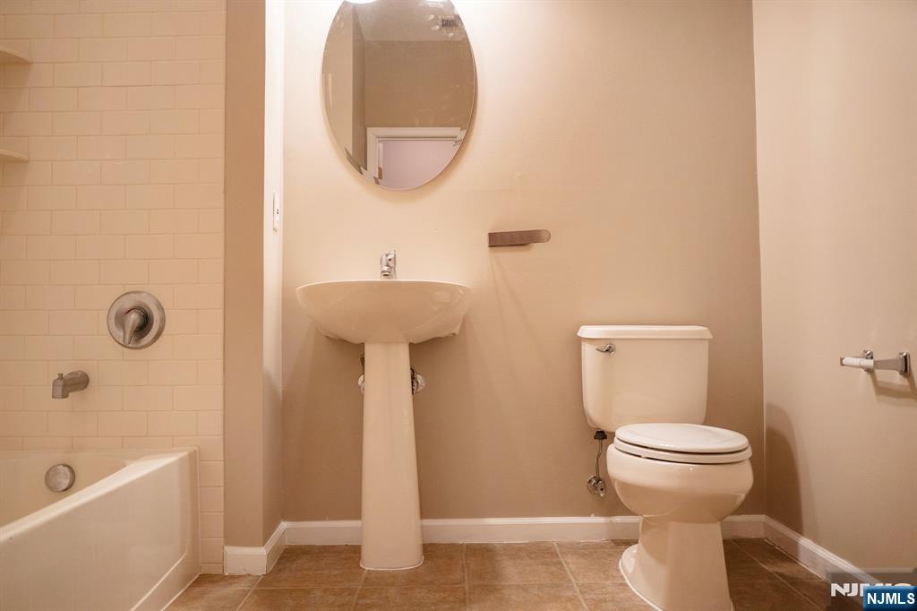 804 River Place Butler, NJ 07405 - Photo 20 of 32 a bathroom with a toilet and a sink
