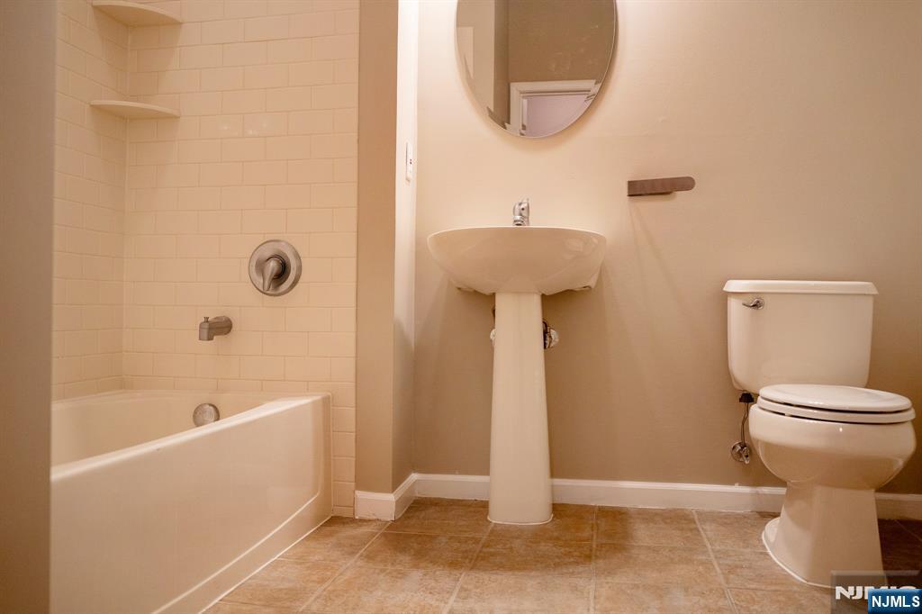 804 River Place Butler, NJ 07405 - Photo 21 of 32 a bathroom with a sink a toilet and bathtub