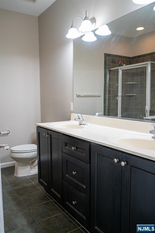 804 River Place Butler, NJ 07405 - Photo 30 of 32 a bathroom with a sink a toilet and a mirror
