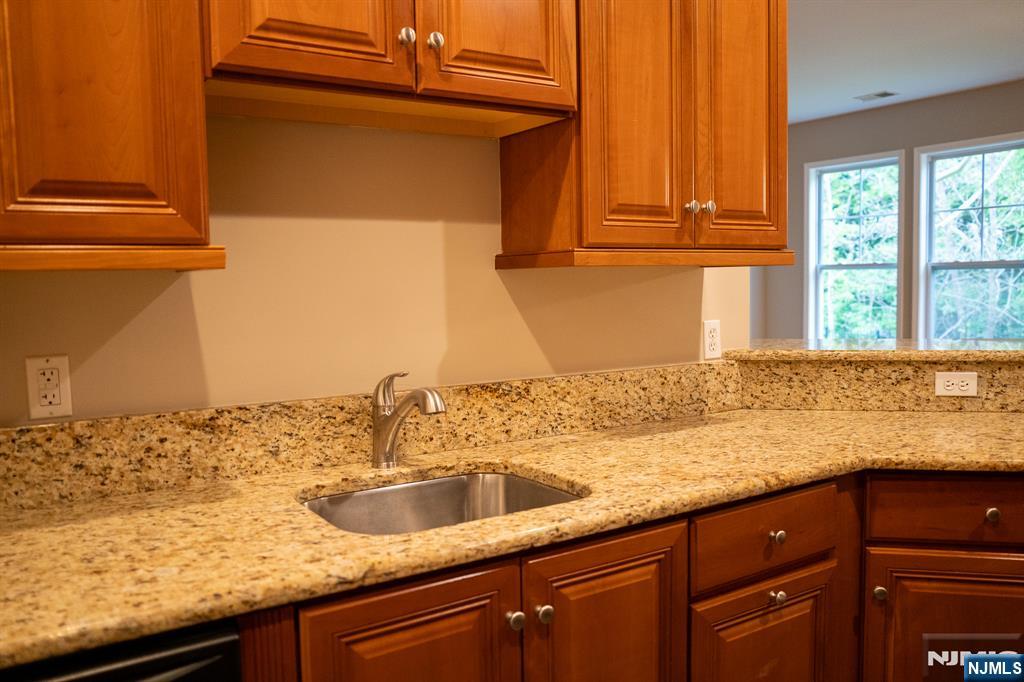 804 River Place Butler, NJ 07405 - Photo 7 of 32 a kitchen with granite countertop a sink and a window