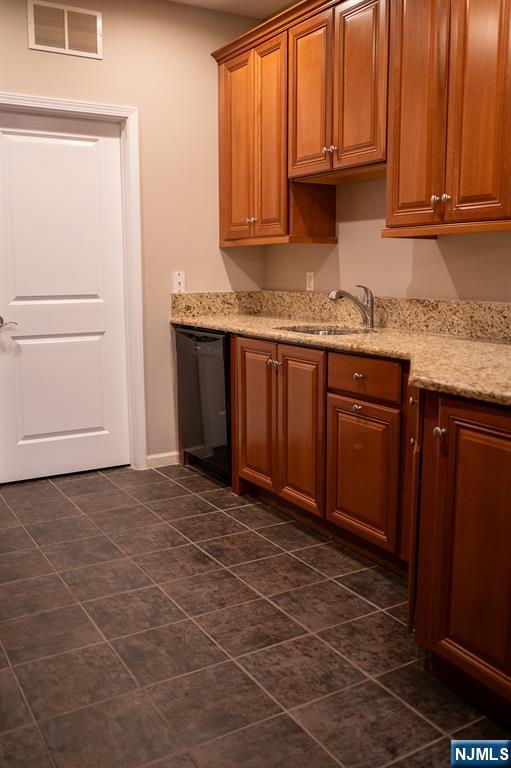 804 River Place Butler, NJ 07405 - Photo 9 of 32 a kitchen with granite countertop a sink and cabinets