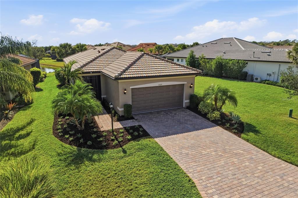 17029 Hampton Falls Terrace Lakewood Ranch, FL 34202 - Photo 1 of 56 an aerial view of a house with a yard