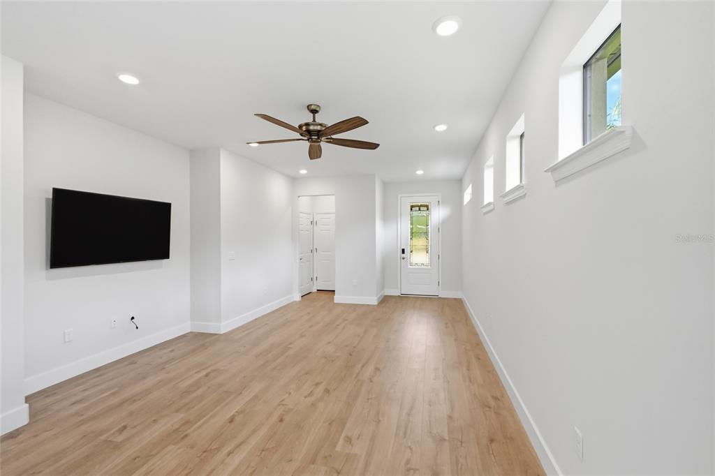 17029 Hampton Falls Terrace Lakewood Ranch, FL 34202 - Photo 14 of 56 a view of a livingroom with a flat screen tv