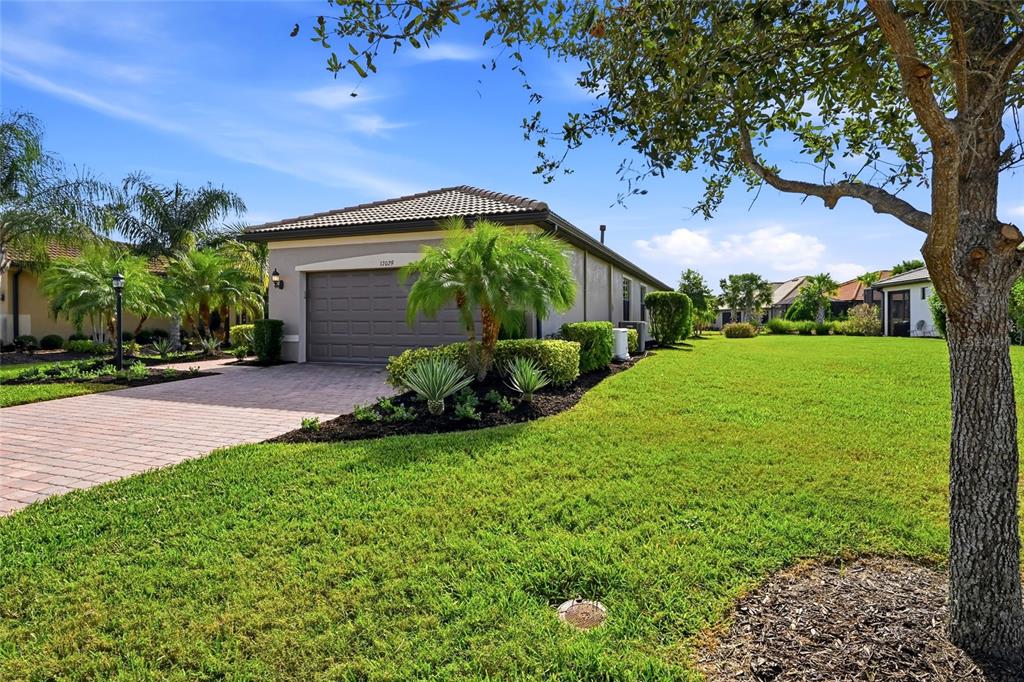 17029 Hampton Falls Terrace Lakewood Ranch, FL 34202 - Photo 2 of 56 a front view of a house with garden