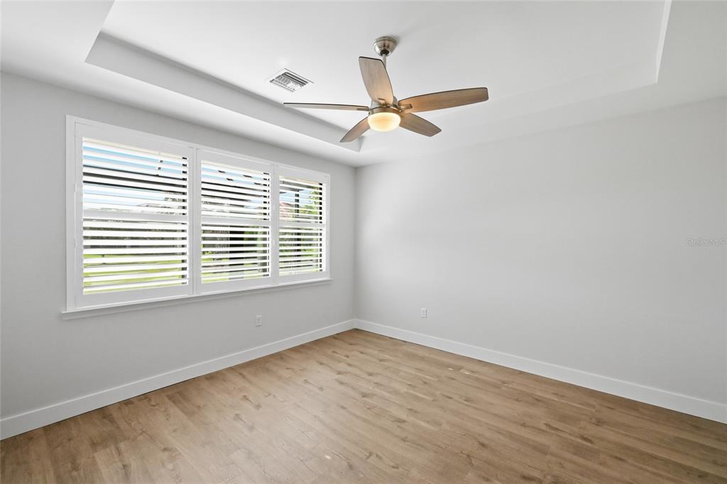 17029 Hampton Falls Terrace Lakewood Ranch, FL 34202 - Photo 22 of 56 wooden floor in an empty room with a window
