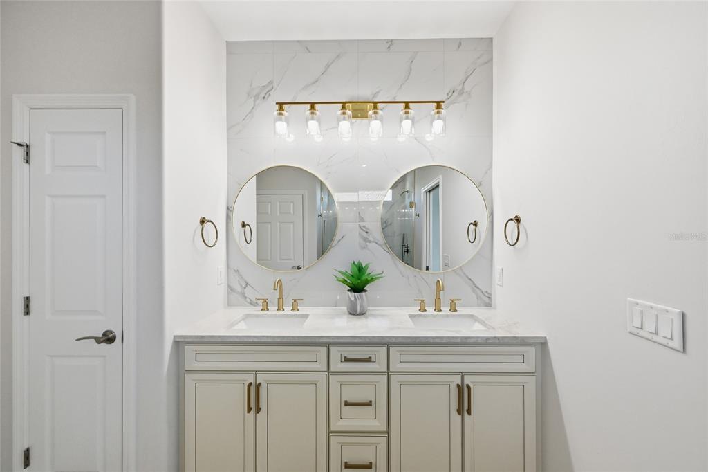 17029 Hampton Falls Terrace Lakewood Ranch, FL 34202 - Photo 25 of 56 a bathroom with double vanity sinks and a mirror