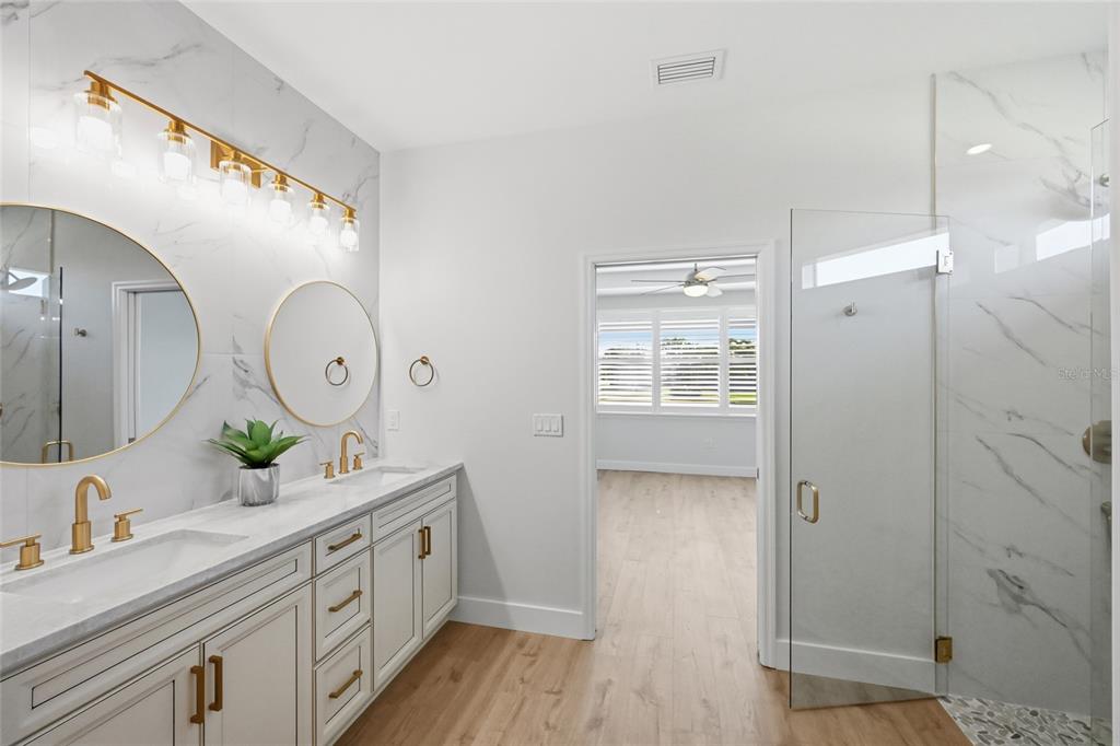 17029 Hampton Falls Terrace Lakewood Ranch, FL 34202 - Photo 28 of 56 a spacious bathroom with a double vanity sink and a mirror